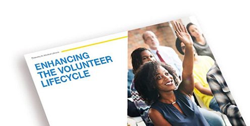 enhancing the volunteer lifecycle ebook cover shows volunteer raising hand